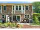 A brick home featuring a cozy backyard patio, with seating, and a sliding glass door entrance at 2495 Northlake Ne Ct, Atlanta, GA 30345