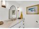 Elegant bathroom featuring a marble countertop, ornate gold fixtures, decorative mirror and lighting at 2495 Northlake Ne Ct, Atlanta, GA 30345