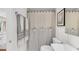 Stylish bathroom featuring striped shower curtain with decorative bows and neutral wall art at 2495 Northlake Ne Ct, Atlanta, GA 30345