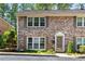Charming brick townhouse with inviting curb appeal and mature landscaping at 2495 Northlake Ne Ct, Atlanta, GA 30345