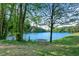 Scenic lake view with trees and a bench, creating a serene and inviting outdoor space at 2495 Northlake Ne Ct, Atlanta, GA 30345