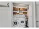 Organized laundry room featuring a washer, dryer, storage baskets, and shelving at 2495 Northlake Ne Ct, Atlanta, GA 30345
