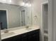 Bathroom with double vanity, dark cabinets, and a large mirror at 4120 Chapel Hill Reserve, Douglasville, GA 30135