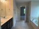 Primary bathroom with dual sinks, soaking tub, and tiled floors at 4120 Chapel Hill Reserve, Douglasville, GA 30135