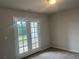 Bedroom with French doors leading to a private balcony overlooking greenery at 4120 Chapel Hill Reserve, Douglasville, GA 30135