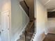 Carpeted staircase with dark wood railing leading to the upper level of the home at 4120 Chapel Hill Reserve, Douglasville, GA 30135