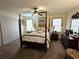 Traditional bedroom with a four-poster bed, neutral decor, and ample natural light at 4409 Deborahs Ct # 0, Union City, GA 30291