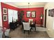 Elegant dining room featuring a dark wood dining table, red accent wall, and art at 4409 Deborahs Ct # 0, Union City, GA 30291