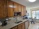 Well-lit kitchen features oak cabinets, granite countertops, modern appliances, and breakfast nook at 4409 Deborahs Ct # 0, Union City, GA 30291