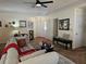 Cozy living room featuring a ceiling fan, plush seating, and neutral walls with decorative mirrors and artwork at 4409 Deborahs Ct # 0, Union City, GA 30291