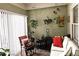Charming sunroom with hanging plants, neutral walls, and comfortable seating for a peaceful indoor oasis at 4409 Deborahs Ct # 0, Union City, GA 30291