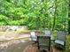 Spacious backyard featuring an outdoor dining area and mature shade trees at 4579 Amberly S Ct, Atlanta, GA 30360