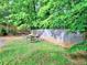 Lush backyard featuring mature trees, green grass, and an outdoor fire pit perfect for Gathering gatherings at 4579 Amberly S Ct, Atlanta, GA 30360