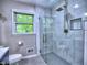 Renovated bathroom with glass shower, elegant tile, and modern fixtures at 4579 Amberly S Ct, Atlanta, GA 30360