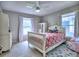 Bright, airy bedroom with white furniture, white-framed windows, and playful decor at 4579 Amberly S Ct, Atlanta, GA 30360