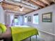 Unfinished basement bedroom with neutral walls, exposed ceiling, and natural light at 4579 Amberly S Ct, Atlanta, GA 30360