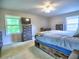 Comfortable bedroom with carpet, natural light, dresser, and large bed with built in storage at 4579 Amberly S Ct, Atlanta, GA 30360
