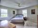 This bedroom features a ceiling fan, bedside table, and two bright, sunlit windows at 4579 Amberly S Ct, Atlanta, GA 30360