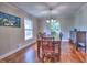 Traditional dining room with hardwood floors, a large table with seating for eight, and ample natural light at 4579 Amberly S Ct, Atlanta, GA 30360