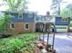 Charming two-story home with brick and siding, a deck, garage, and landscaped front yard at 4579 Amberly S Ct, Atlanta, GA 30360