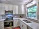 Well-lit kitchen with stainless steel appliances, stylish backsplash, and ample counter space at 4579 Amberly S Ct, Atlanta, GA 30360