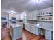Modern kitchen with white cabinets, stainless appliances, island, and wood floors at 4579 Amberly S Ct, Atlanta, GA 30360