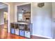 Cozy living room with brick fireplace, hardwood floors, and custom shelving unit at 4579 Amberly S Ct, Atlanta, GA 30360