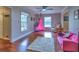 Bright living room featuring hardwood floors, neutral walls, and a playful hammock chair at 4579 Amberly S Ct, Atlanta, GA 30360