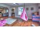 Open-concept living area with hardwood floors, hammock chair, and neutral color palette at 4579 Amberly S Ct, Atlanta, GA 30360