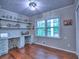 Bright home office featuring built-in shelves, desk space, and hardwood flooring at 4579 Amberly S Ct, Atlanta, GA 30360