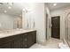 Elegant bathroom boasts double vanity, framed mirrors, and a glass shower enclosure at 719 Hammond Dr, Woodstock, GA 30188