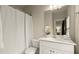 Clean bathroom with shower, a large vanity, and decorative mirror at 719 Hammond Dr, Woodstock, GA 30188