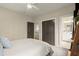 Comfortable bedroom with ceiling fan features hallway and ensuite bathroom access at 719 Hammond Dr, Woodstock, GA 30188