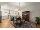 Charming dining room with hardwood floors, modern lighting, and flows into the kitchen at 719 Hammond Dr, Woodstock, GA 30188