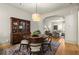 Charming dining room with hardwood floors, modern lighting, and flows into the living room at 719 Hammond Dr, Woodstock, GA 30188