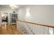 Hallway with hardwood floors and a staircase, complemented by natural light at 719 Hammond Dr, Woodstock, GA 30188