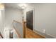 Upstairs hallway features hardwood floors and decorative lighting at 719 Hammond Dr, Woodstock, GA 30188