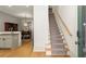 Open-concept kitchen next to a staircase and entryway, creating a welcoming transition at 719 Hammond Dr, Woodstock, GA 30188