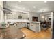 Open kitchen featuring granite countertops, stainless steel appliances, and access to dining area at 719 Hammond Dr, Woodstock, GA 30188