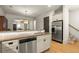 Kitchen with stainless steel appliances, granite countertops, and hardwood flooring near the stairs at 719 Hammond Dr, Woodstock, GA 30188