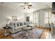 Cozy living room with hardwood floors, modern furniture, fireplace and large sunny windows at 719 Hammond Dr, Woodstock, GA 30188