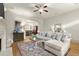 Cozy living room with hardwood floors, modern furniture, fireplace and open archways to kitchen at 719 Hammond Dr, Woodstock, GA 30188