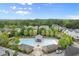 Aerial view of neighborhood pool with lounge chairs and mature trees and landscaping at 719 Hammond Dr, Woodstock, GA 30188