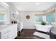 Bright bathroom with double vanities, a freestanding tub, and natural light at 737 Dushea Nw Ct, Kennesaw, GA 30144