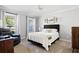 Cozy bedroom with neutral tones, carpet, and a comfortable bed, illuminated by natural light from two windows at 737 Dushea Nw Ct, Kennesaw, GA 30144