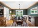 Elegant dining room with dark green walls, hardwood floors, and plenty of natural light at 737 Dushea Nw Ct, Kennesaw, GA 30144