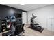 Modern home gym features sleek black wall, light wood floors, and exercise equipment at 737 Dushea Nw Ct, Kennesaw, GA 30144