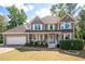 Charming two-story home with a manicured lawn, complemented by a welcoming front porch at 737 Dushea Nw Ct, Kennesaw, GA 30144