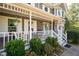 Charming front porch with swing, decorative plants and inviting curb appeal at 737 Dushea Nw Ct, Kennesaw, GA 30144