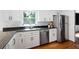Bright kitchen with stainless steel appliances, white cabinets, and a window over the sink at 737 Dushea Nw Ct, Kennesaw, GA 30144